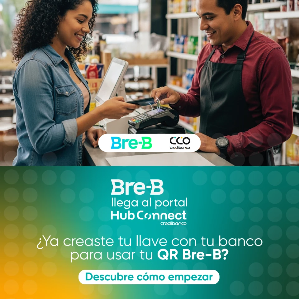 Banner promocional de Bre-B y Credibanco mostrando a una mujer pagando con su celular en un datáfono atendido por un cajero en una tienda. El diseño incluye un fondo degradado en tonos verde y amarillo con el texto: ‘Bre-B llega al portal HubConnect Credibanco. ¿Ya creaste tu llave con tu banco para usar tu QR Bre-B? Descubre cómo empezar’.
